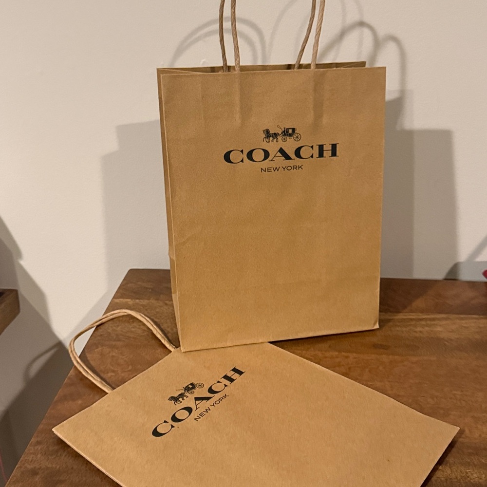 Coach Small/Med gift bag. 8 x 10 in. Iconic carriage logo in black. Handles.